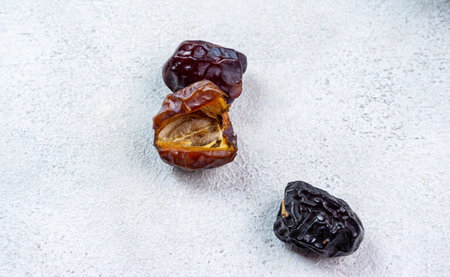 Raw Organic Arabic Dates, Ajwa Dates on light gray background. Ramadan Kareem. Close up.の写真素材