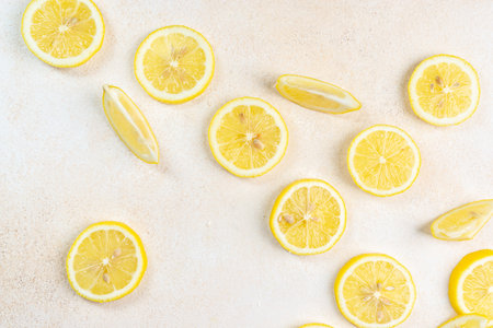 Fresh slices of lemons on bright background. Lemon fruit citrus. Summer theme, healthy fruit.の写真素材