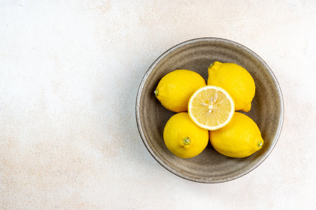 Fresh lemons on bright background. Lemon fruit citrus. Composition with whole, slices of lemons.の写真素材