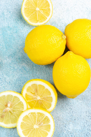 Fresh lemons on bright background. Lemon fruit citrus. Composition with whole, slices of lemons.の写真素材