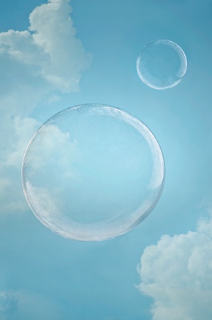 Day dreaming. Two floating soap bubbles against blue sky with copyspaceの写真素材
