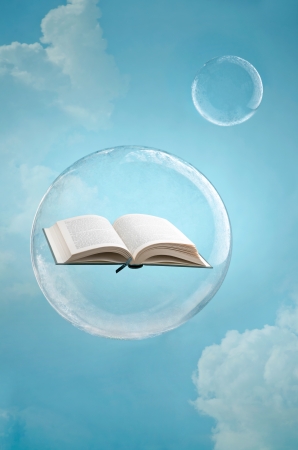 Magic of books. Open book floating in a soap bubble in the skyの写真素材