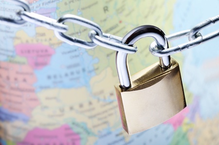 Closeup of padlock on world map representing global security conceptの写真素材