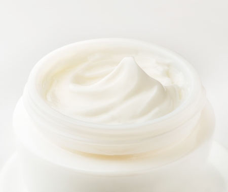 Moisturizing cream in an open jar  Close-up view の写真素材
