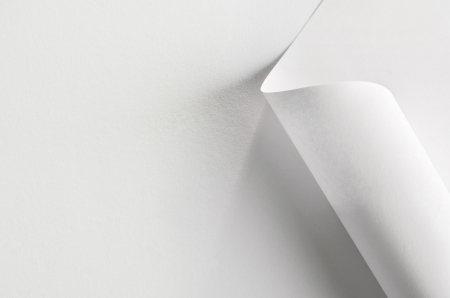 White paper, partially rolled up, close-upの写真素材