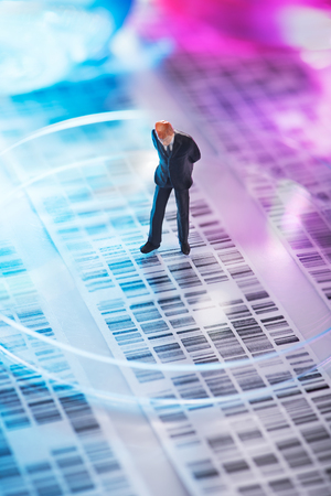 Man looking at DNA gel into petri dishの写真素材