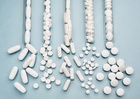 Test tubes with various white pillsの写真素材