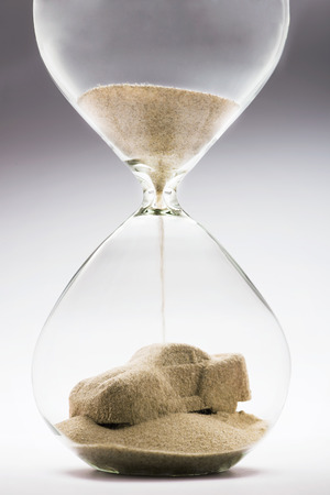 Car rental concept with falling sand taking the shape of a carの写真素材