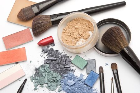 Eye shadow, powder, lipstick, blush and brushes on makeup artist table