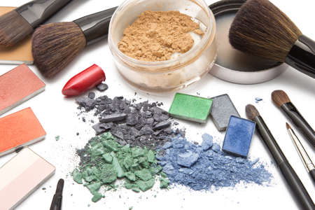Eye shadow, lipstick, powder, blush and brushes on makeup artist tableの写真素材