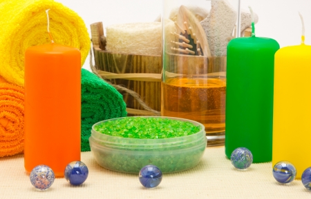 Candles, sea salt, shower gel with towels and other bathroom accessoriesの写真素材