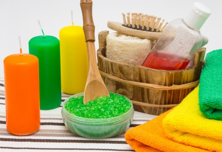 Candles, sea salt, shower gel with towels and other bathroom accessoriesの写真素材