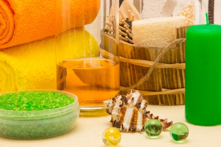 Candles, sea salt, shower gel with towels and other bathroom accessoriesの写真素材
