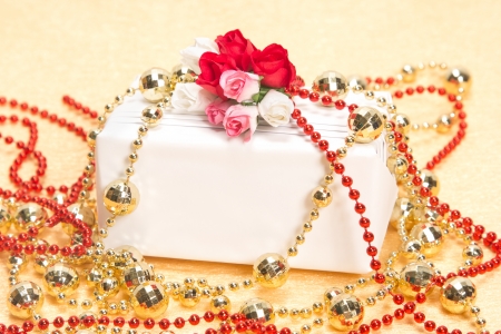 White gift box with paper flowers and beadsの写真素材