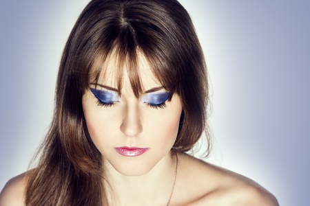 Portrait of beautiful girl with eyes closed, flowing hair and bright make-upの写真素材
