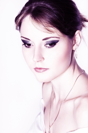 Portrait of beautiful pensive girl with white glowing skin and bright make-upの写真素材