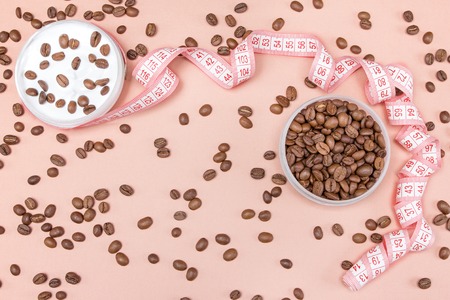 Anti-cellulite cream with caffeine concept  cream, coffee beans and measure tapeの写真素材