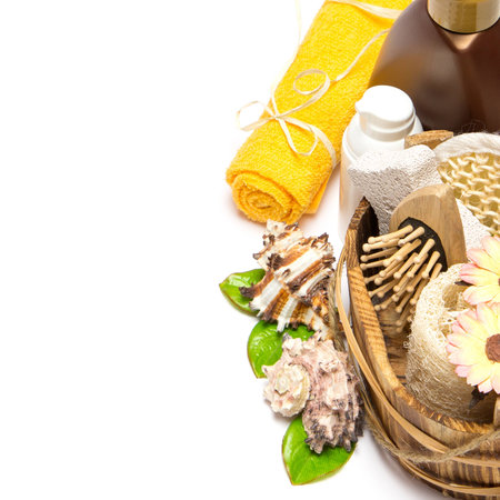 Loofah, pumice, comb in wooden basket, shower gel, towel on white backgroundの写真素材