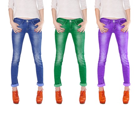 Shapely female legs dressed in blue, green and violet jeans