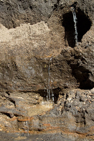 Natural background and texture. Small waterfall near the creek, stony soilの写真素材