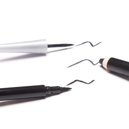 Different kinds of black eyeliners on white backgroundの写真素材