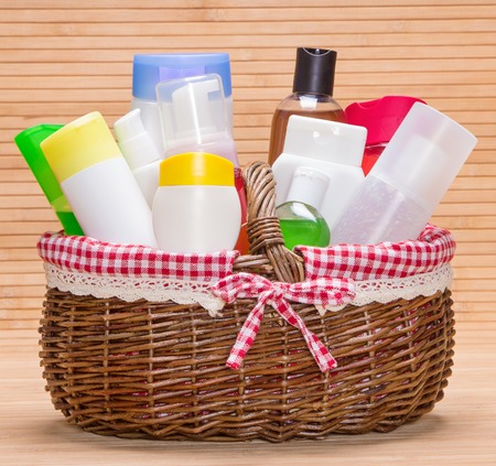 Wicker basket filled with different cosmetic products for body careの写真素材