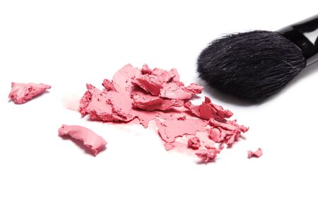 Close-up of smeared cream blush with makeup brush on white background. Shallow depth of fieldの写真素材