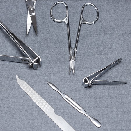 Various stainless steel manicure tools: nail clippers, nail and cuticle scissors, nailfile, double...