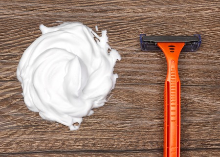 Close-up of disposable razor with sample of shaving foam. Top viewの写真素材