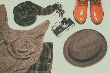 British fashion style women outfit with vintage film camera. Retro chic set. Toned imageの写真素材