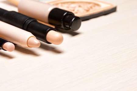 Make-up products to hide skin imperfections. Different concealers. Side view, copy space