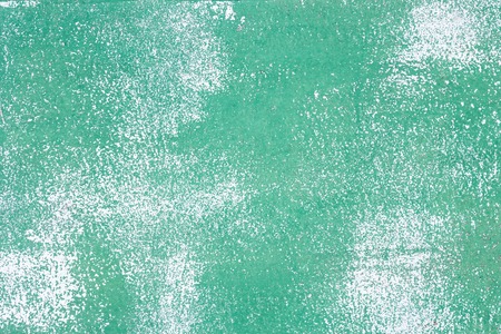 Texture of white surface with peeling green paint. Shabby background