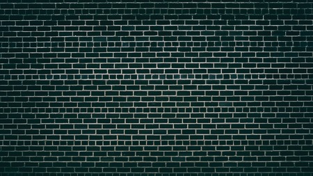Emerald black brick wall with convex mortar joints. Dark brickwork texture. Grunge backgroundの写真素材
