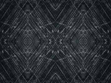 Spacious black repetitive texture of weathered concrete surface forming a whimsical pattern. Dark...