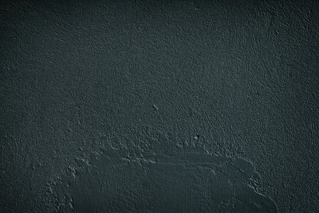 Black rough grain concrete wall. Fine textured cement plaster surface. Dark grunge backgroundの写真素材