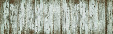 Wide rustic vintage background. Shabby aged wooden planks with peeling paint. Wood retro textureの写真素材