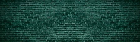 Wide dark bright teal brick wall. Old brickwork texture. Retro grunge panoramic backgroundの写真素材