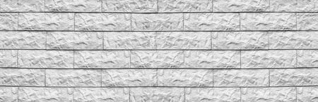 Wide white cement tile wide texture. Whitewashed stone block masonry panoramic background. Rough...