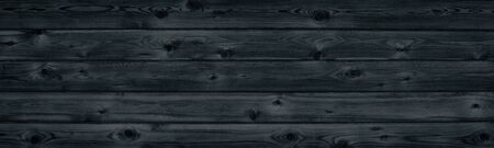 Black wooden board texture wide panorama. Wood pattern long surface. Dark retro backgroundの写真素材