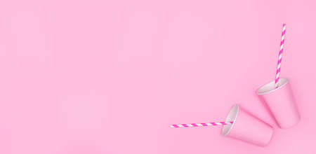 Two pink paper cups with striped drinking straws on pink background. Large copy space. Girly party, sweet beverage minimal conceptの写真素材