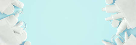 Cosmetic products in white paper merchandise bags on blue background. Buying cosmetics. Beauty shopping and sale banner. Large copy spaceの写真素材