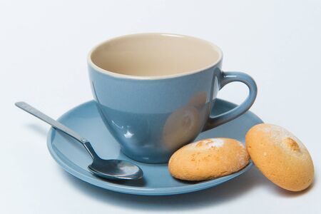 Empty tea cup with homemade cookies isolated on white backgroundの写真素材