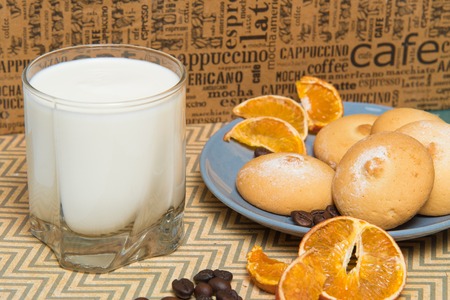 glass of milk and plate with cookiesの写真素材