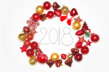 Top view on frame made of christmas decoration with new year balls on isolated white background with inscription 2018の写真素材