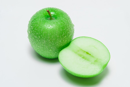 Closeup green apple with water-drops isolated on white backgroundの写真素材