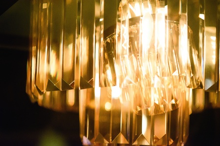 Closeup view of contemporary light fixture in dark roomの写真素材