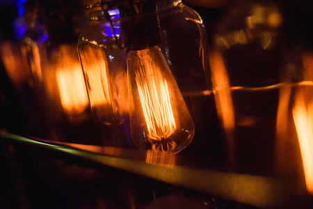 Closeup view of contemporary light fixture in dark roomの写真素材