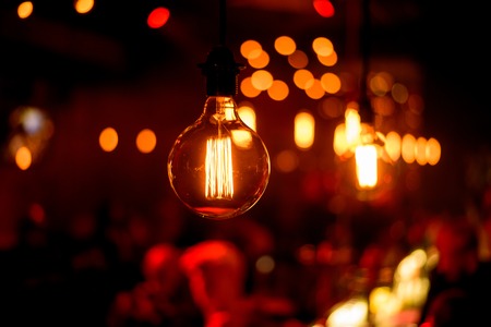 Closeup view of contemporary light fixture in dark roomの写真素材