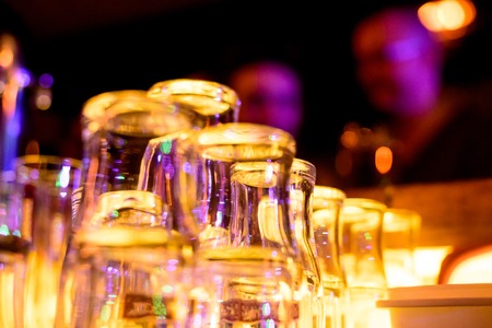 Empty glasses on table in night club or restaurant, closeupの写真素材