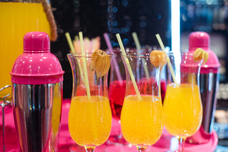 Alcohol bar, cocktail glass on bar counter, cocktail glass in a bar, Drinking cocktail in bar, cocktail in the glass with straws, Fresh drink coctailの写真素材